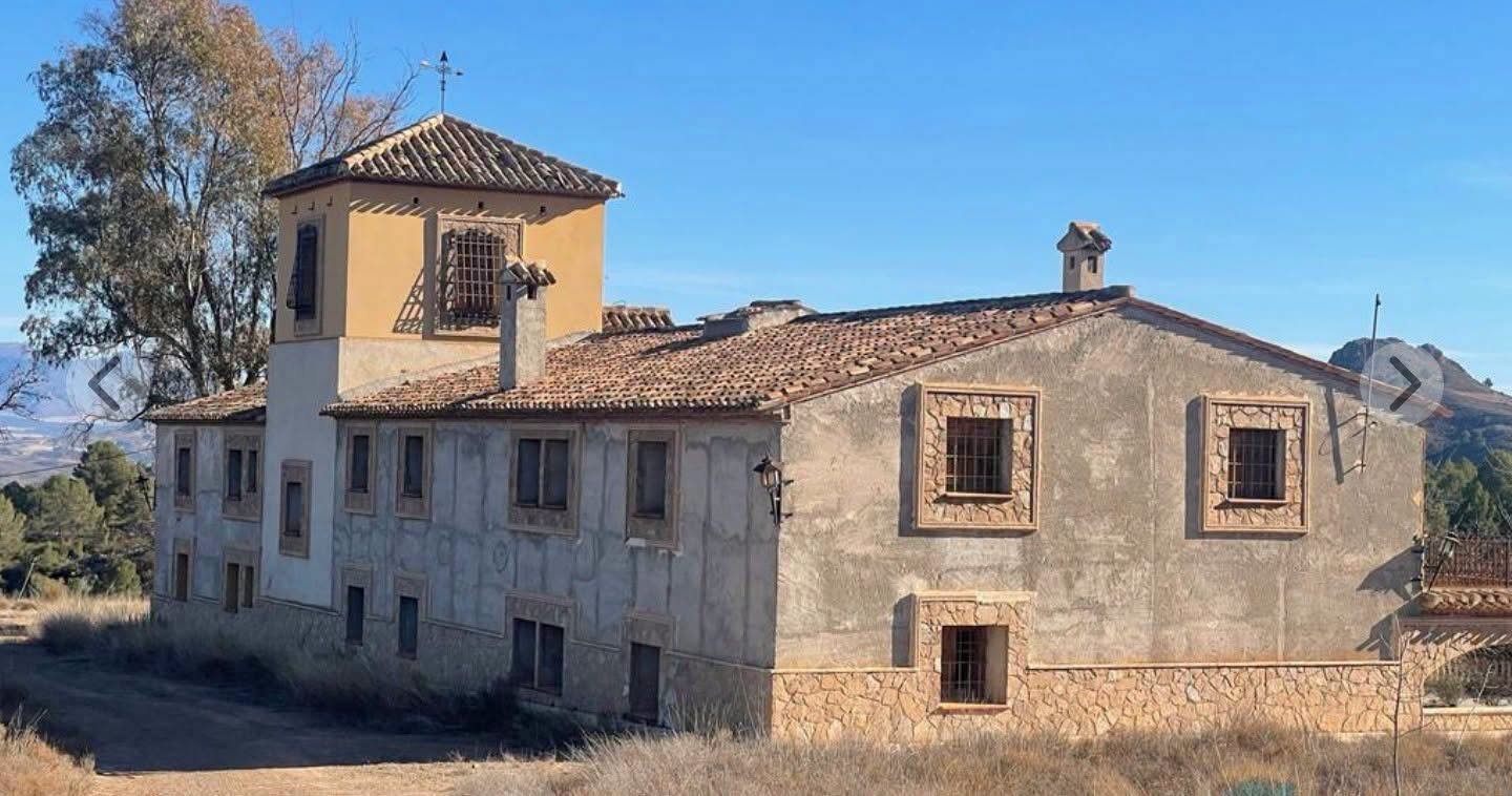 Facade with tower and stone window surrounds, Lorca estate