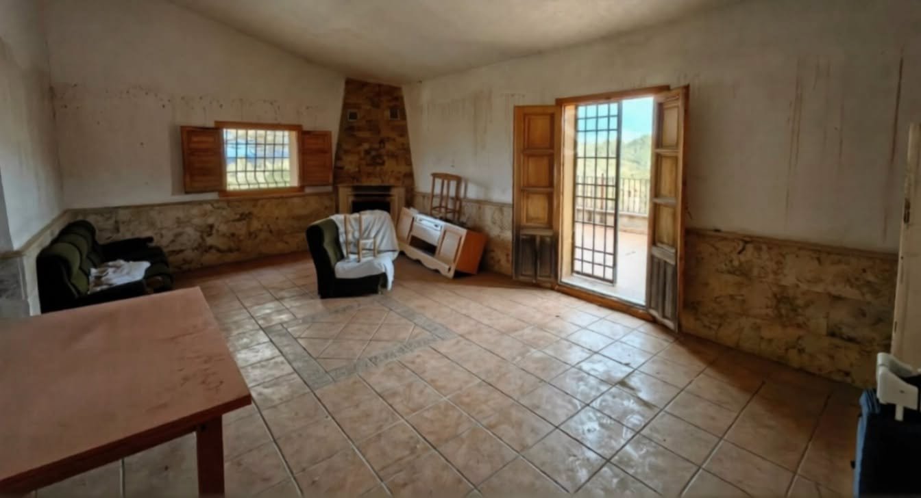 Living room with fireplace and balcony door, Lorca estate